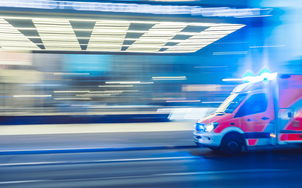 Representing the hospital them of Grey's Anatomy, this picture is an ambulance in motion. The shutter speed for this picture is creating a blurred effect to show how fast the ambulance is traveling under a well-lite tunnel-like structure.