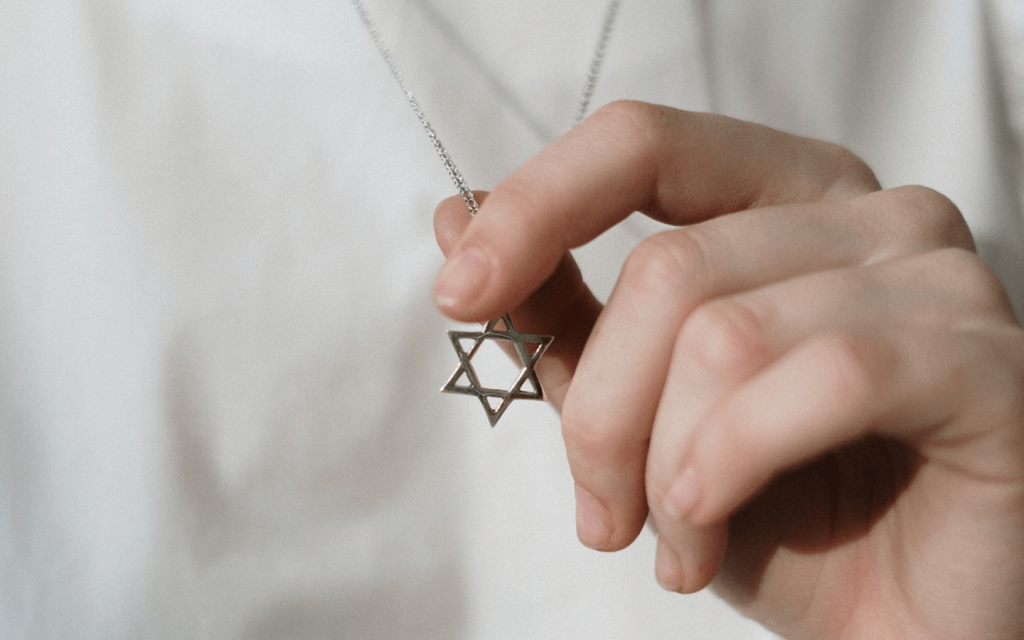 This is the hand of a white woman-holding-a-star-of-david, used to represent the role of religion in "Unorthodox".